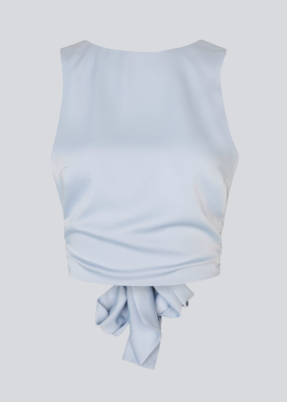 Ærmeløs top i satin i lysegrålig blå. TailorMD top har en åben ryg som lukkes med et bindebånd. Modellen er 177 cm og har en str S/36 på.