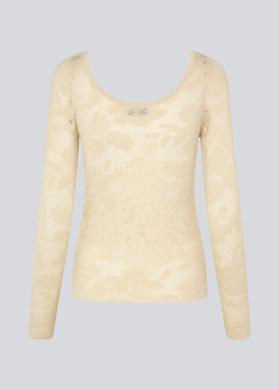 Tætsiddende top i beige i stretchy blonde, der er en smule gennemsigtig. HawkinsMD top har lange ærmer og en dyb udskæring både foran og bagved.