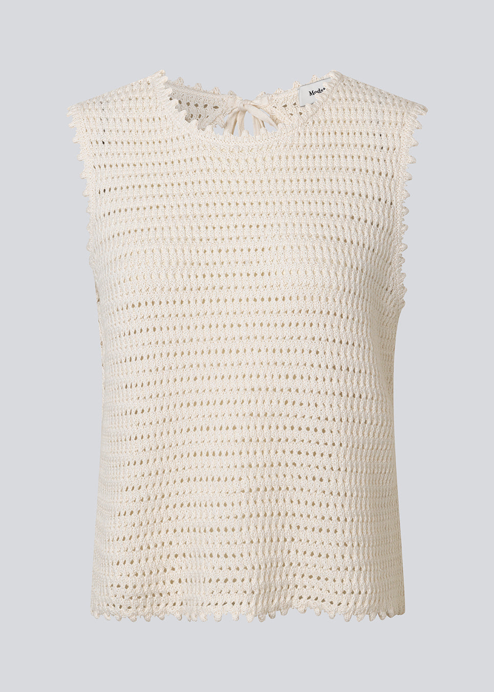 Hæklet top uden ærmer i økologisk bomuld. MieMD top har detaljerede kanter og en dyb rygudskæring.
