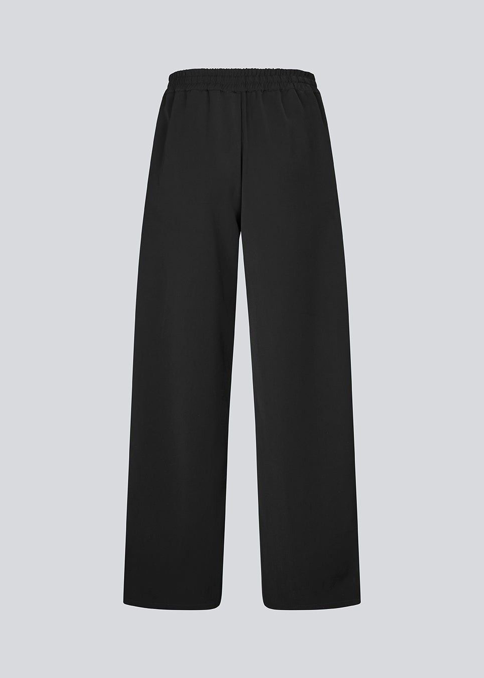 Loose black trousers with wide legs and a relaxed fit. Featuring an elastic waistband with drawstring for a comfortable, adjustable waist. White side stripes add a sporty and modern touch to the otherwise classic design. Perfect for casual everyday wear or more elevated styling – easy to pair with everything from t-shirts to dressy tops.