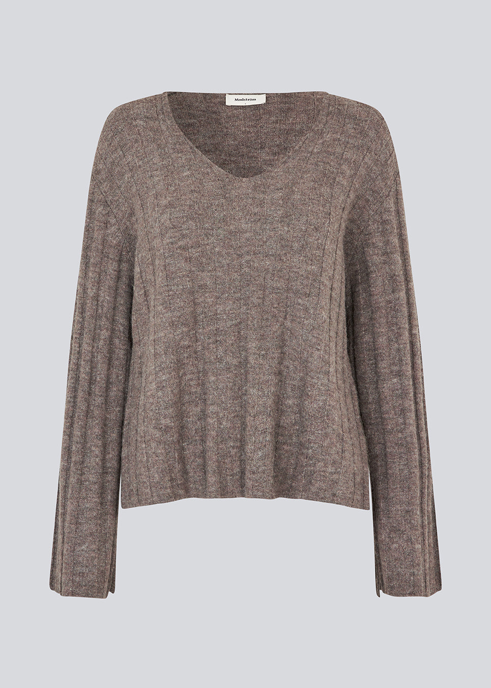 Blød strik i brun med lange ærmer og V-udskæring.  Treemd v-neck har en løs pasform og en slids ved ærmet. 