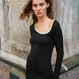 Tætsiddende maxi-kjole i strækbar rib. FaizMD dress har lange ærmer med slids, slids i siden af skørtet og asymmetrisk halsudskæring med kontrasterende kant. Modellen er 175 cm og har en størrelse S/36 på.