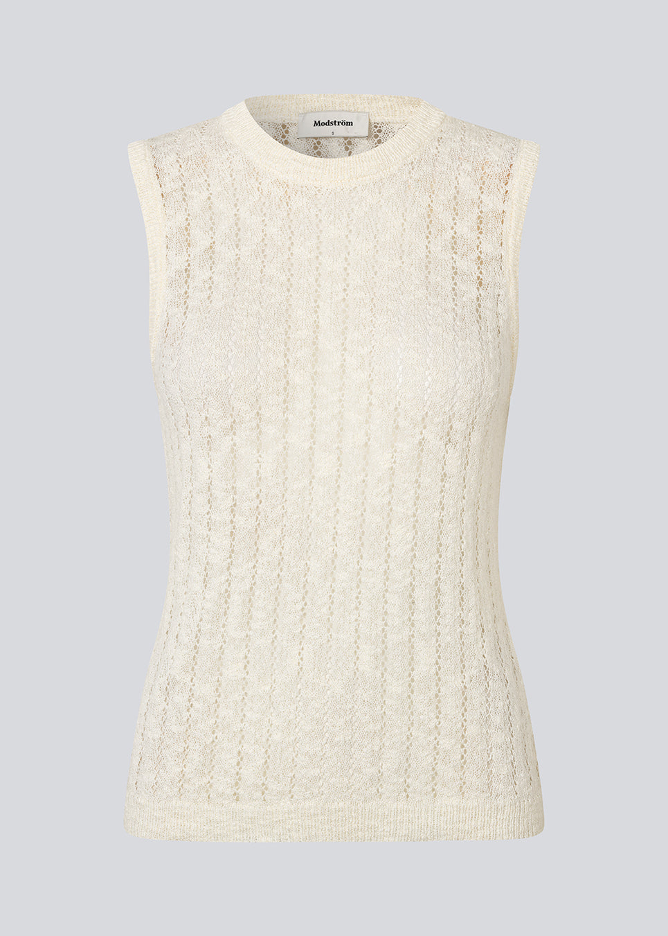 Ærmeløs top i gennemsigtigt strikmønster. AgnesMD Top har rund halsudskæring og er perfekt til lag-på-lag styling. En moderne og let top, der kombinerer elegance med alsidighed.