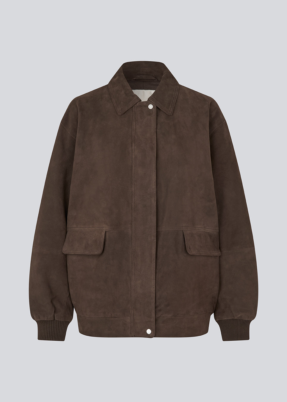 Cool ruskindsjakke med et afslappet udtryk. Barkmd jacket er designet i en oversized pasform med klassisk krave, skjult trykknaplukning og ribkanter ved manchetter og forneden, der giver et moderne bomberinspireret look. De store frontlommer fuldender det funktionelle design og gør jakken til en stilfuld favorit, der kan bruges sæson efter sæson.