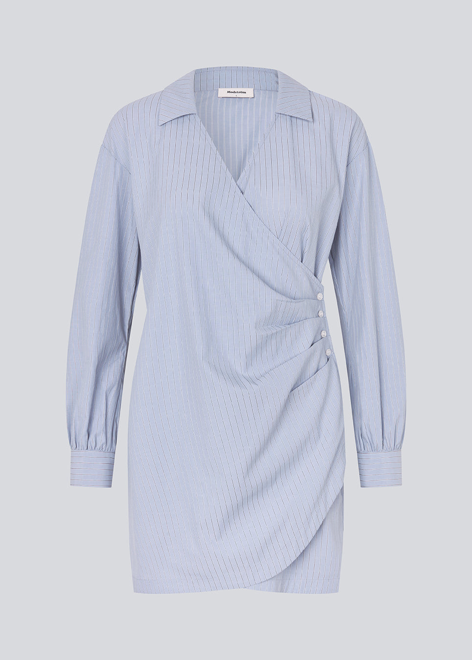 Kort asymmetrisk kjole med skjortereferencer. BrodieMD Dress har krave, V-hals, manchetter og en slå-om detalje med knapper og presse – en trendy og flatterende style, der giver et moderne og effortless look.