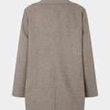 Cecarmd Jacket er en klassisk dobbeltradet jakke med en afslappet, oversized pasform. Designet er fuldendt med brede revers, klaplommer og en aftagelig blomsterbroche, som tilfører et feminint og dekorativt element. Den bløde uldblanding gør jakken ideel som overgangsjakke eller som et elegant lag over sæsonens strik og tailoring.