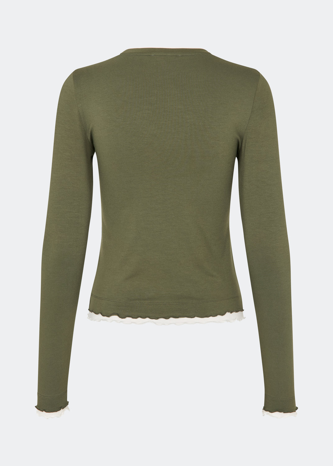 Langærmet T-shirt i en blød og komfortabel kvalitet. CiljaMD LS T-shirt har en tætsiddende silhuet med rund halsudskæring og dekorative kontrastkanter ved hals, manchetter og forneden, som skaber en lag-på-lag-effekt. De bølgede afslutninger tilfører et feminint touch til det enkle design, hvilket gør den perfekt både alene og som et lag under strik, skjorter eller jakker.