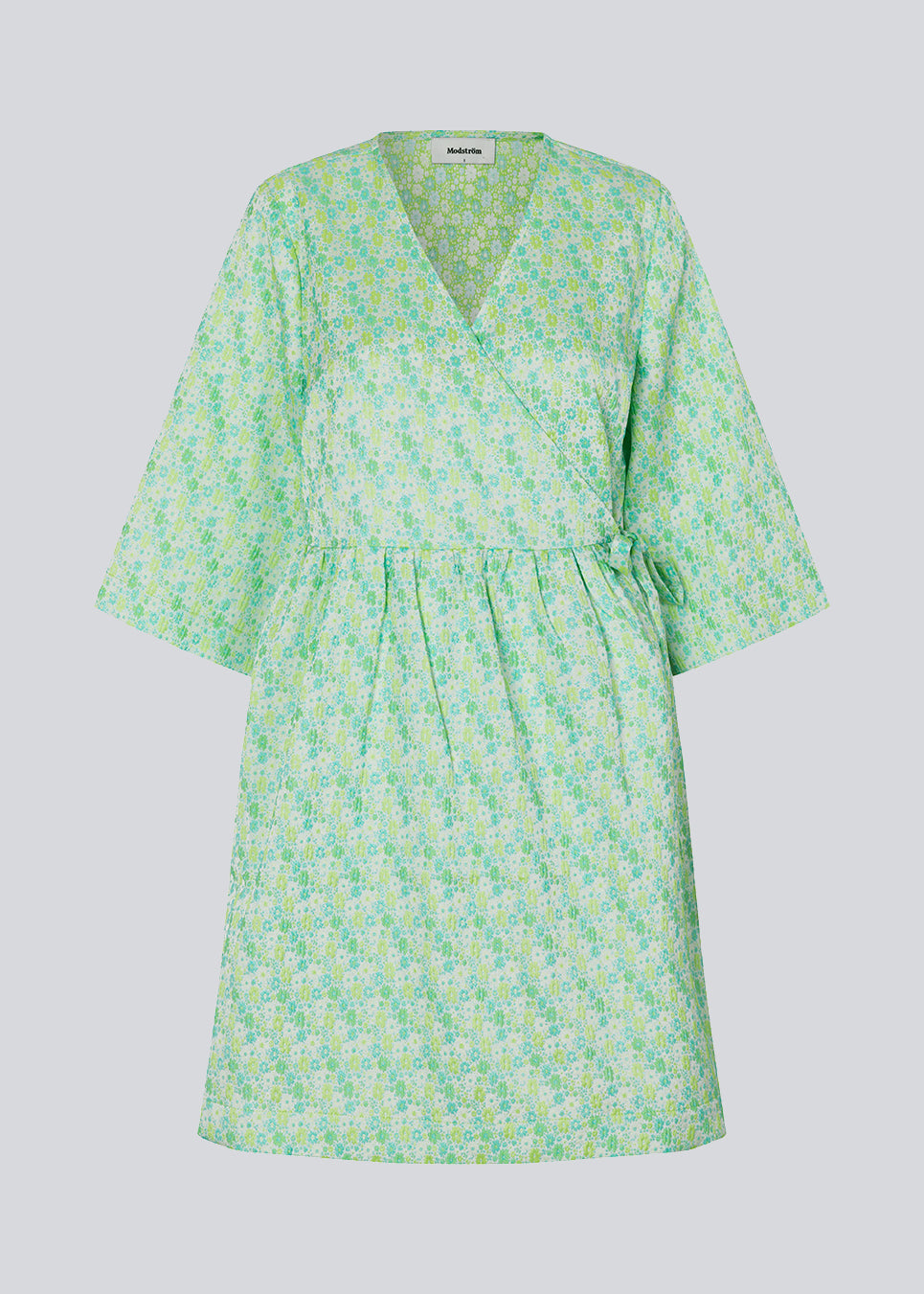 Kort kjole i struktureret materiale. DorianMD wrap dress har v-halsudskæring, brede ærmer i albuelængde og bindelukning. Modellen er 177 cm og har en størrelse S/36 på.