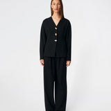 Doritmd Blazer er en feminin blazer med en figursyet silhuet og et elegant, kraveløst design. De organiske guldfarvede knapper skaber et eksklusivt udtryk, mens de formsyede paneler fremhæver taljen og giver en flatterende pasform. Style den med de matchende bukser eller over en kjole for et moderne og sofistikeret look.