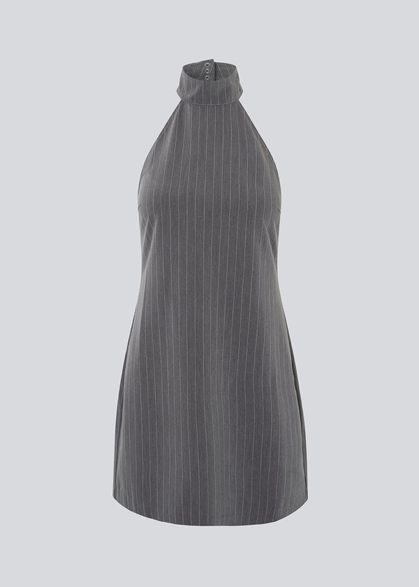 Kort figursyet kjole i grå pinstripe med halterneck. EmiliaMD halterneck dress har en knappelukning i nakken og en usynlig lynlås i ryggen.
