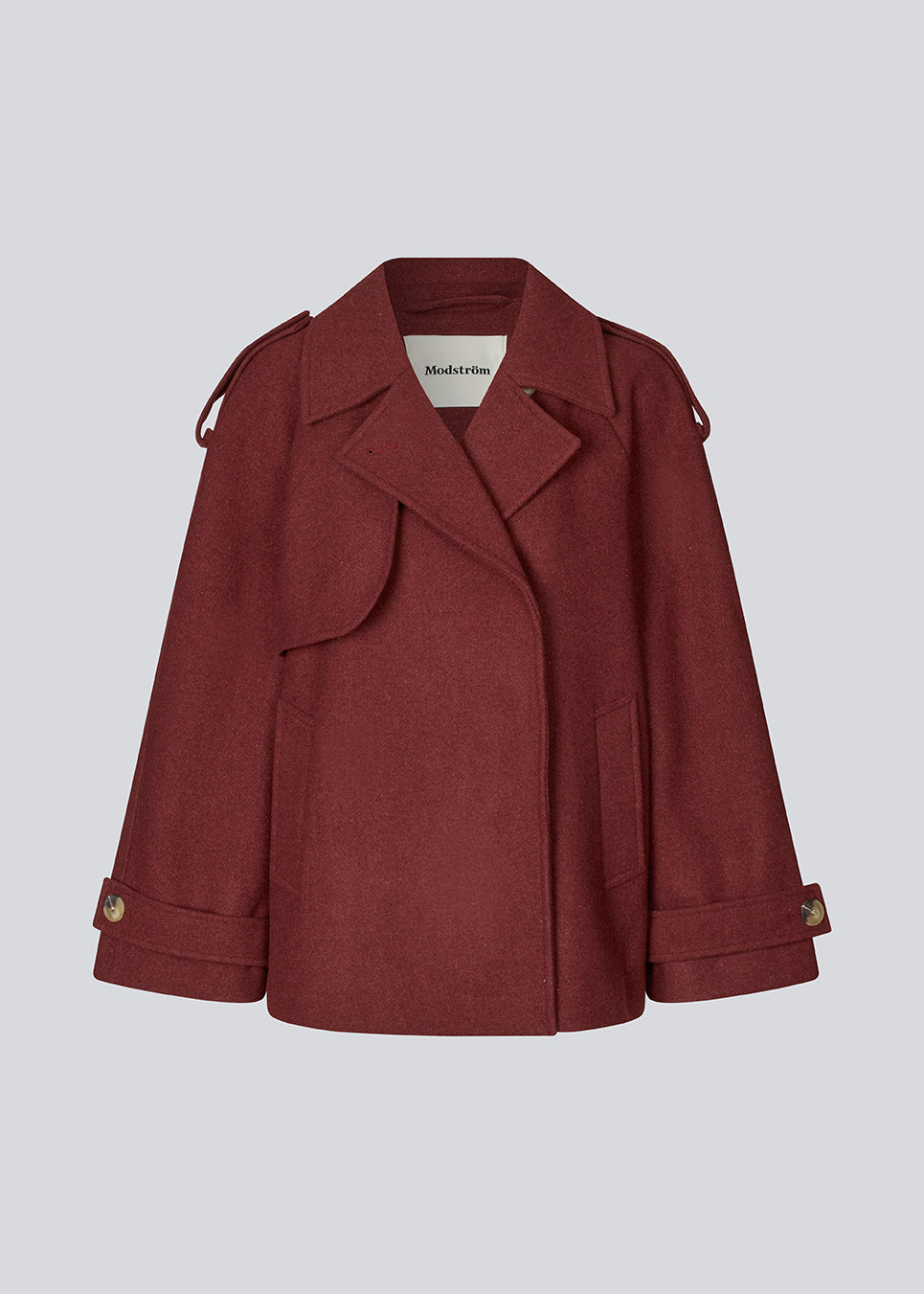 Cropped dobbeltradet uldfrakke med skjulte knapper. EsmundMD jacket har klassiske frakkedetaljer med raglanærmer og bredt bærestykke på ryggen. Med foer.&nbsp;