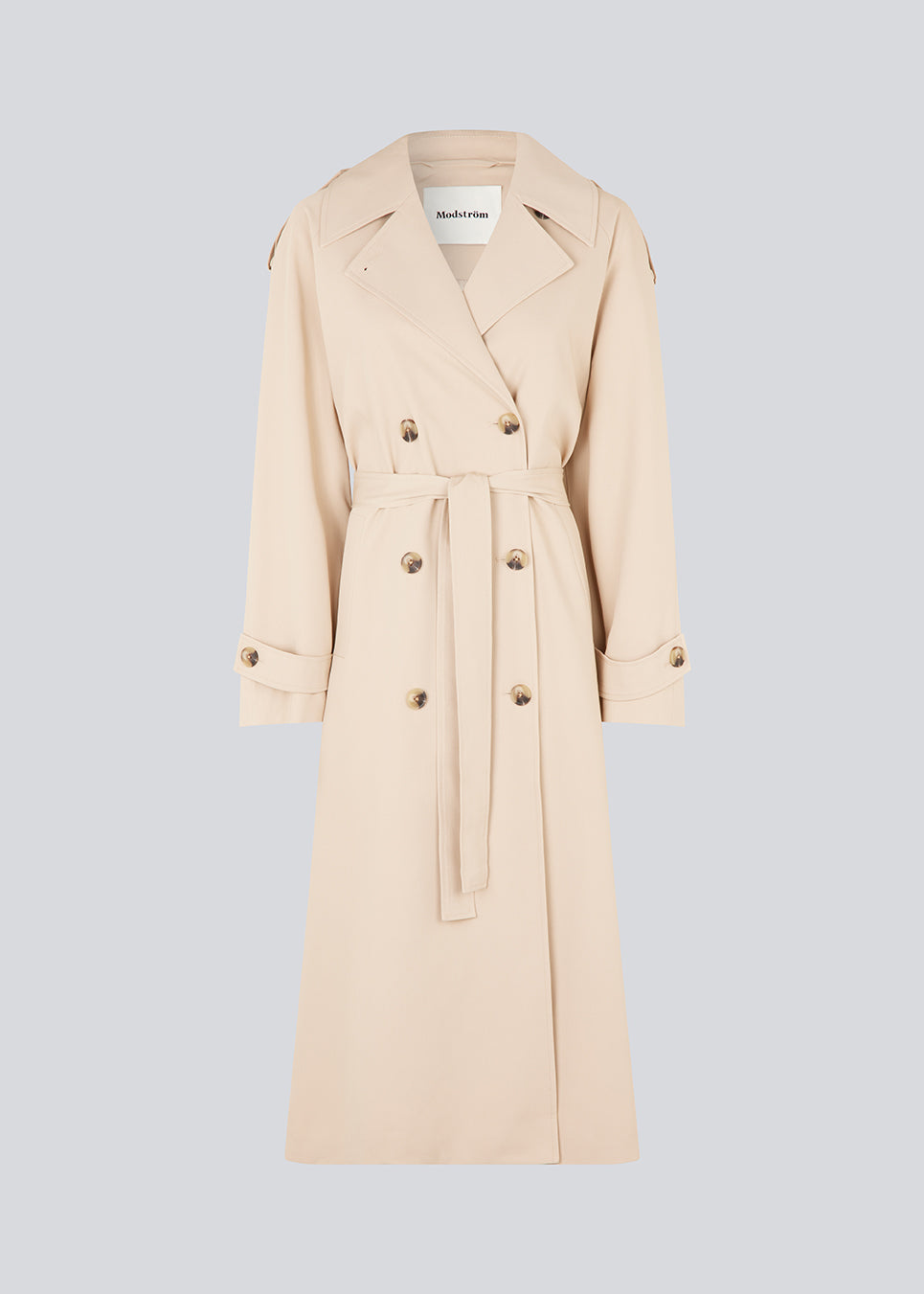 Oversized dobbeltradet trench coat i lys beige med bindebånd i taljen. EvieMD jacket har lav skuldersøm og lange, brede ærmer. Med foer. Modellen er 175 cm og har en størrelse S/36 på.