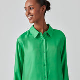 Grøn skjorte i kvalitet af silke med løs pasform. FableMD shirt har krave og knaplukning fortil, lange ærmer med vidde og bred manchet. Modellen er 175 cm og har en størrelse S/36 på.