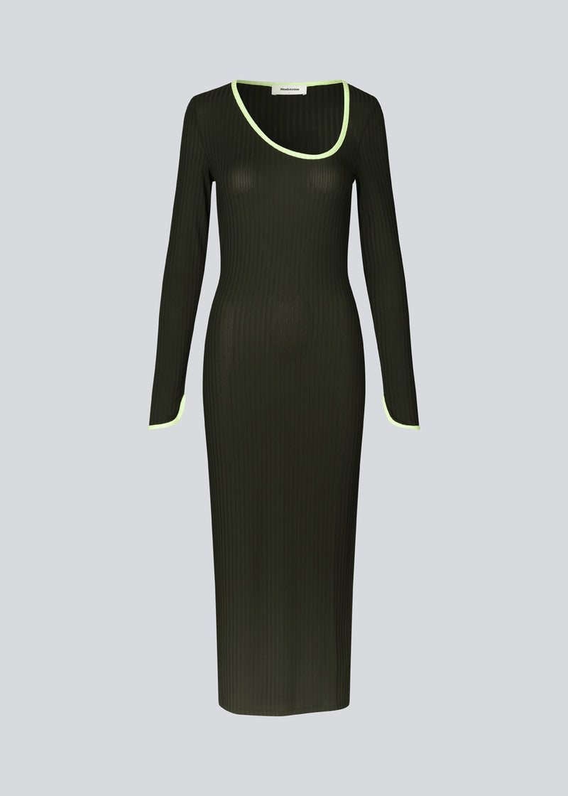 Tætsiddende maxi-kjole i strækbar rib. FaizMD dress har lange ærmer med slids, slids i siden af skørtet og asymmetrisk halsudskæring med kontrasterende kant. Modellen er 175 cm og har en størrelse S/36 på.