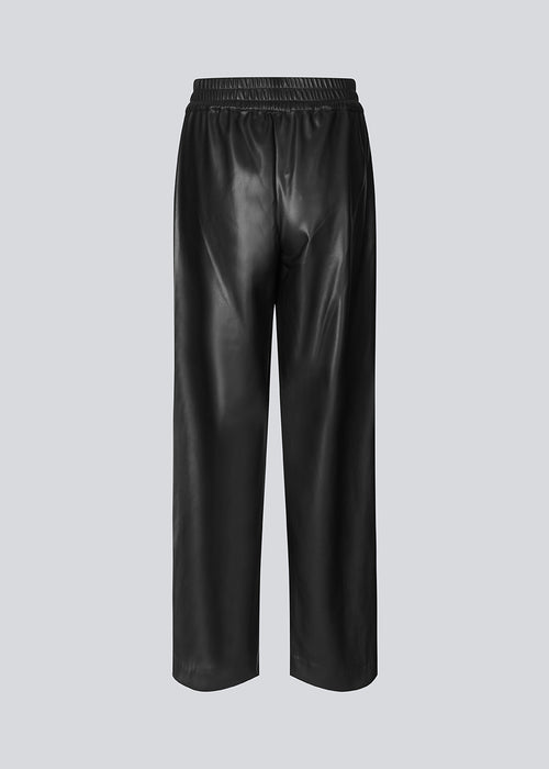 Faux læder bukser med lige, brede ben. FaminaMD pants har en høj talje med elastik og er foret for ekstra komfort. Modellen er 175 cm og har en størrelse S/36 på.  Style bukserne med matchende skjorte i samme fa