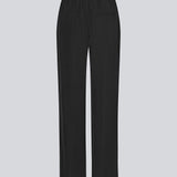 FanyaMD pants i sort har et herre-inspireret look med lige, brede ben, høj talje med lynlåsgylp og knap og elastik bagpå. Dobbeltlæg foran og sidelommer. 