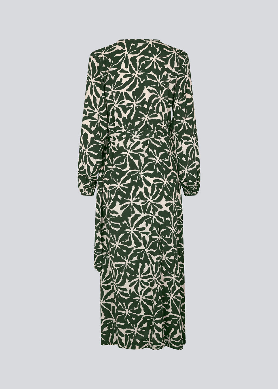 Midi-kjole i printet EcoVero viskose med v-udskæring og wrap-effekt foran. FernMD print wrap dress har bredt bindebælte i taljen og lange ballonærmer. Modellen er 175 cm og har en størrelse S/36 på.