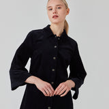Midi skjortekjole i fløjl i mørkeblå med krave og trykknapper foran. FikaMD dress har et rummeligt fit med A-silhuet og 3/4 lange brede ærmer. Modellen er 175 cm og har en størrelse S/36 på.