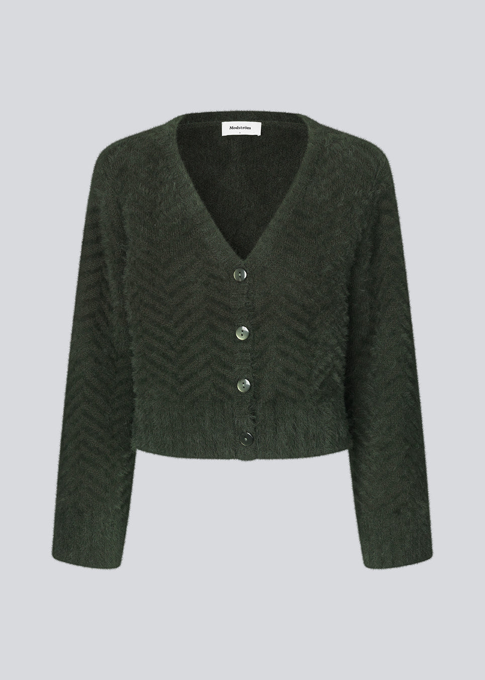 Lodden cardigan i bomuldsblanding i mørkegrøn. FloriaMD cardigan har en afkortet form, v-udskæring, lange brede ærmer og knaplukning fortil. Modellen er 175 cm og har en størrelse S/36 på.