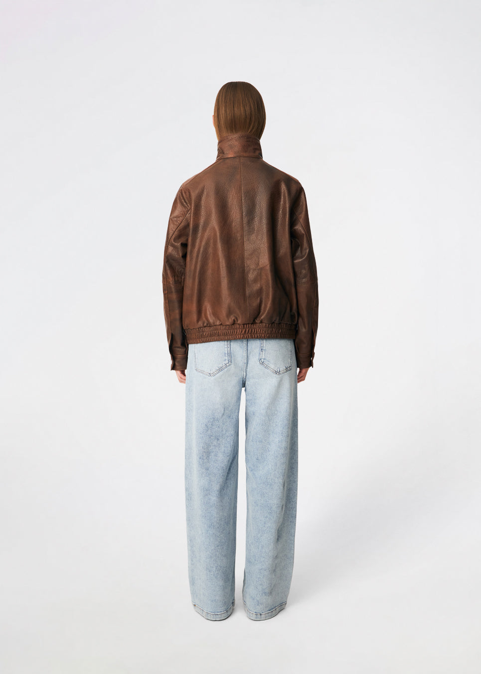 Statement-jakke i læderlook med et moderne udtryk. Forestmd jacket er designet i en afslappet pasform med høj ståkrave, skjult asymmetrisk lukning og elastisk kant forneden, der giver et cool, bomberinspireret look. Den strukturerede læderlook-overflade tilfører karakter, mens den oversized silhuet gør jakken til et alsidigt valg, der nemt kan styles til både afslappede og mere elegante outfits.