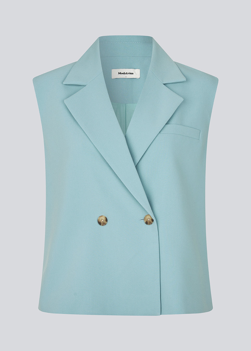 Løs habit vest i blå med krave i vores klassiske gale materiale. Galemd vest er ærmeløs og har en knappelukning fortil. Modellen er 175 cm og har en str. S/36 på.