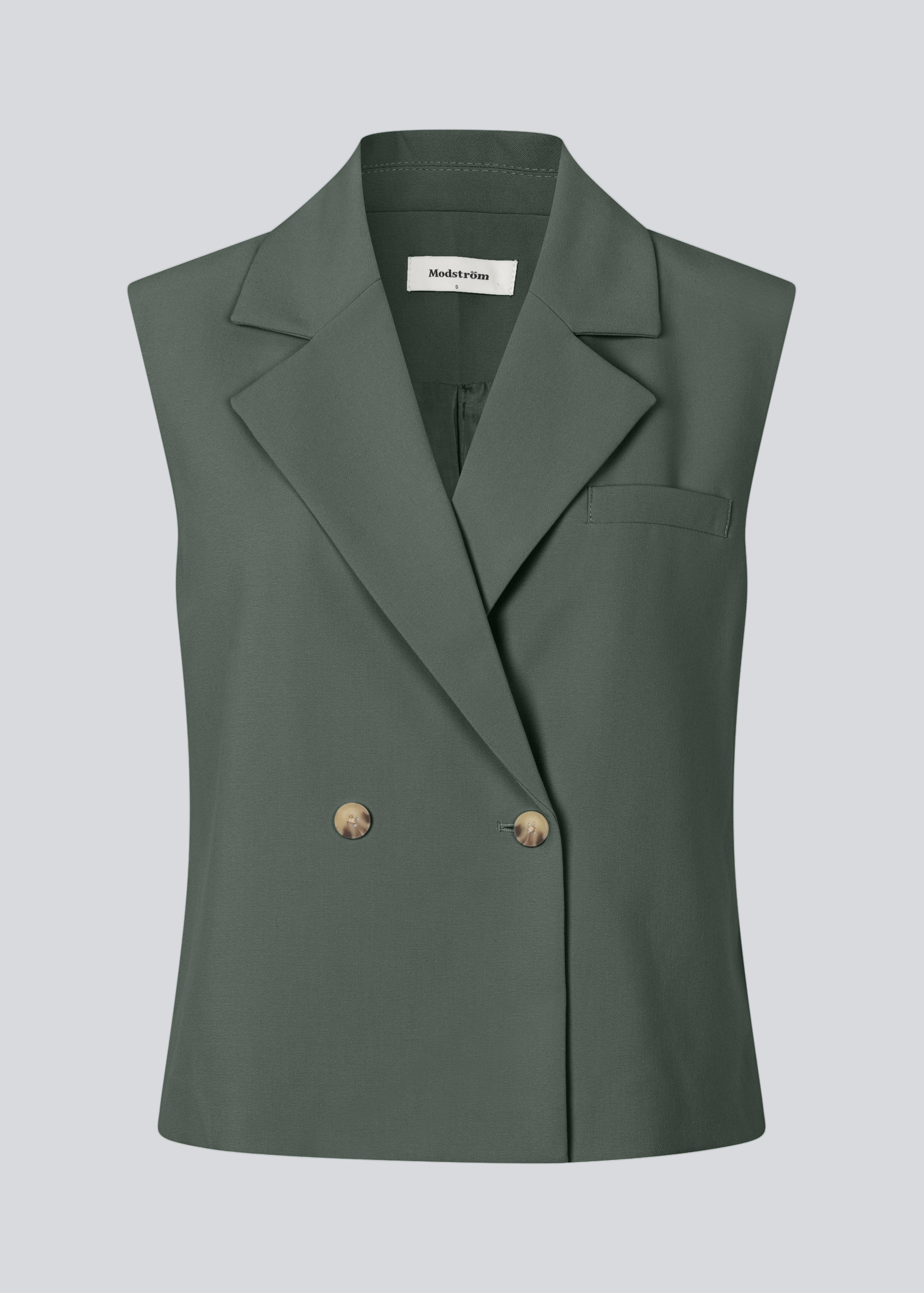Løs vest i mørkegrøn med krave i vores klassiske gale materiale. Galemd vest er ærmeløs og har en knappelukning fortil.&nbsp;