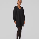 Sort kjole med en løs silhuet i struktureret materiale. GemmiMD dress har lange, voluminøse ballonærmer med manchet og v-udskæring i halsen. Modellen er 175 cm og har en størrelse S/36 på.