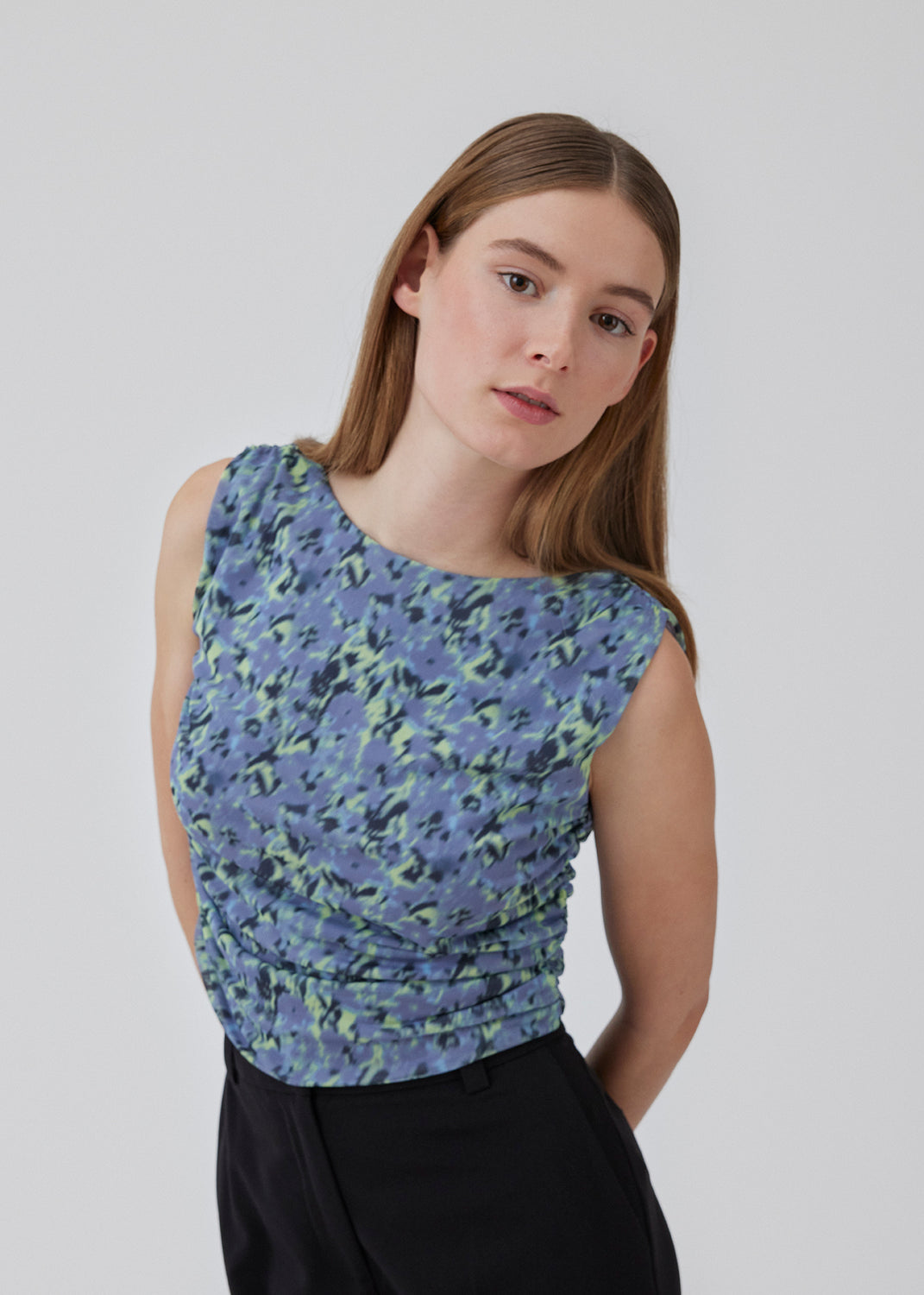 Kort, tætsiddende top i genanvendt kvalitet med print. HamiltonMD print top har høj bådudskæring, ingen ærmer og elastiske rynkedetaljer i siderne og ved skuldersømmen. Modellen er 175 cm og har en størrelse S/36 på.<br>