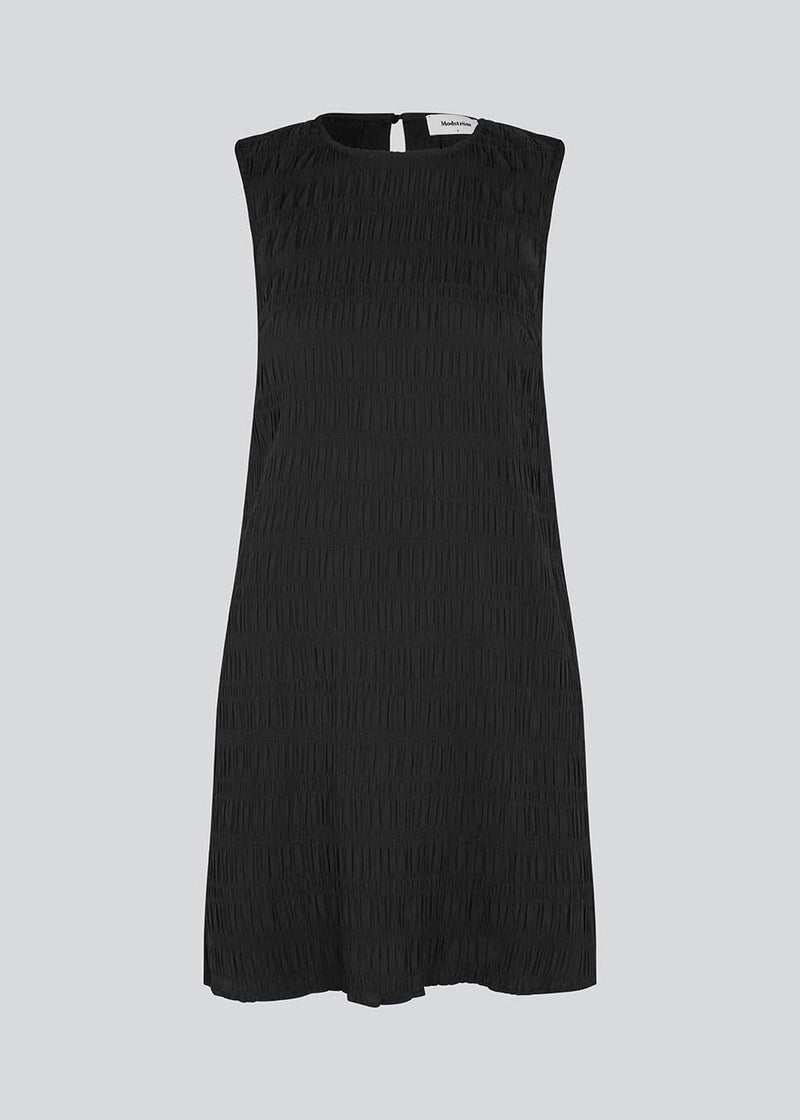 HamsonMD dress har en A-formet pasform uden ærmer og med rund hals. HamsonMD dress har en åbning bagpå med knaplukning. Modellen er 175 cm og har en størrelse S/36 på.