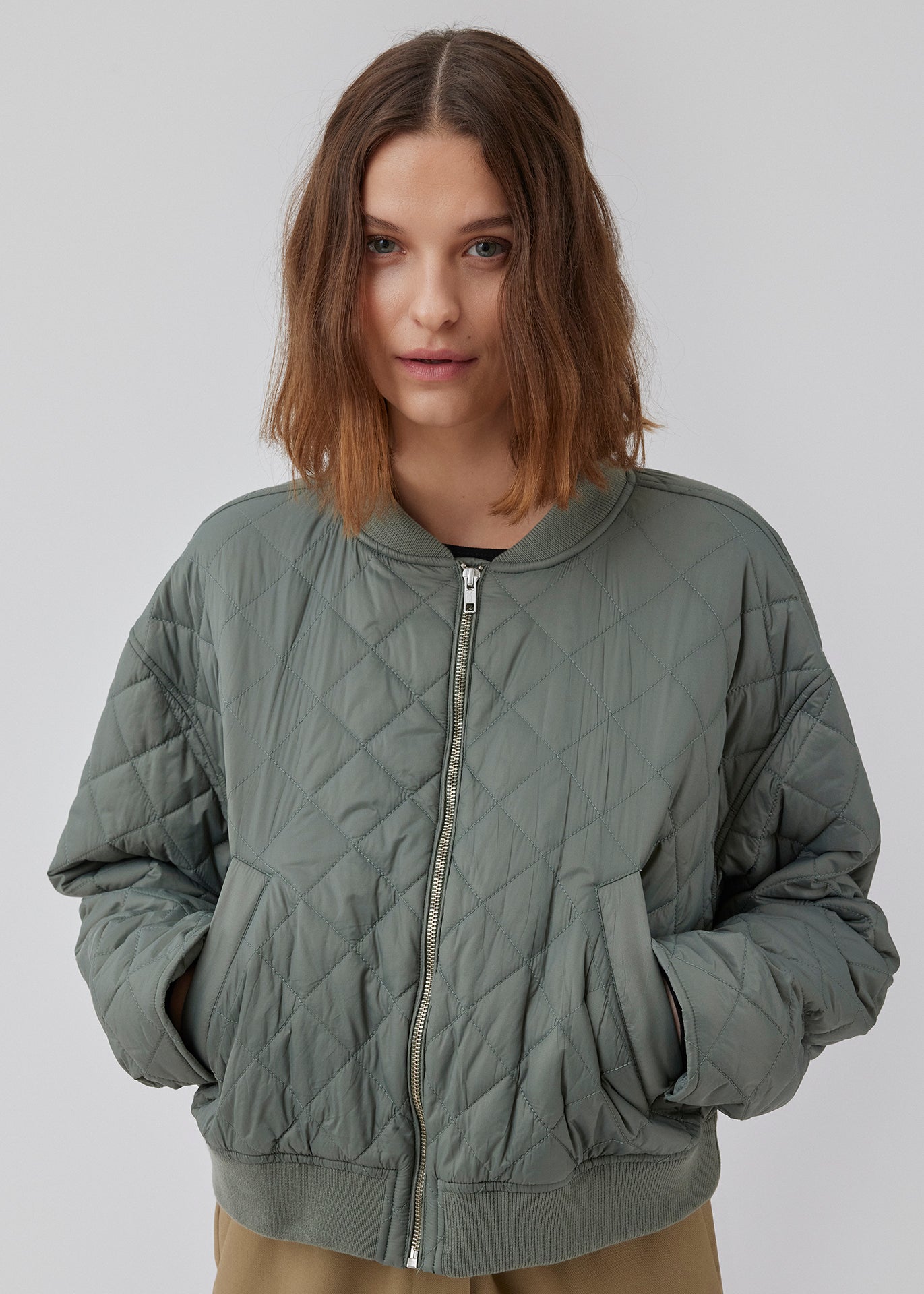 Let vatteret jakke i quiltet kvalitet med kort, ribbet krave og lynlås foran. HankMD jacket har en kort og løs facon. Produceret i genanvendt nylon. Modellen er 175 cm og har en størrelse S/36 på.