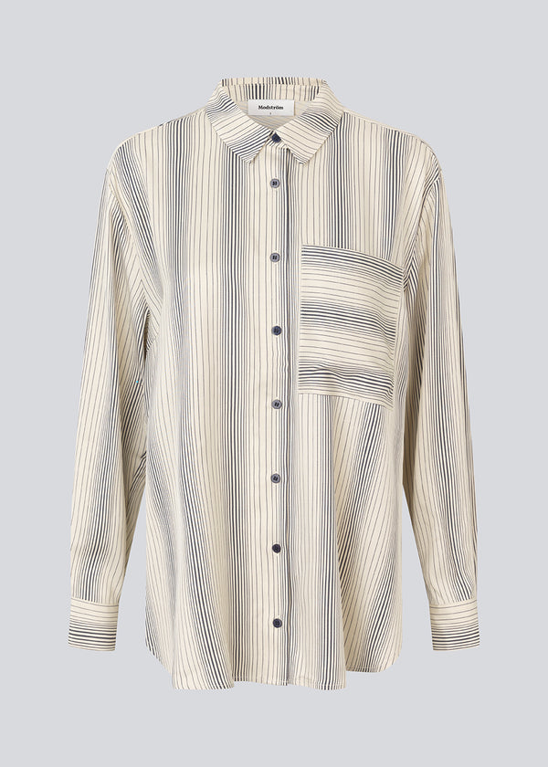 Oversize skjorte med krave og knaplukning fortil. HissaMD print shirt har brede ærmer med manchet og detaljeret bærestykke bagpå. 