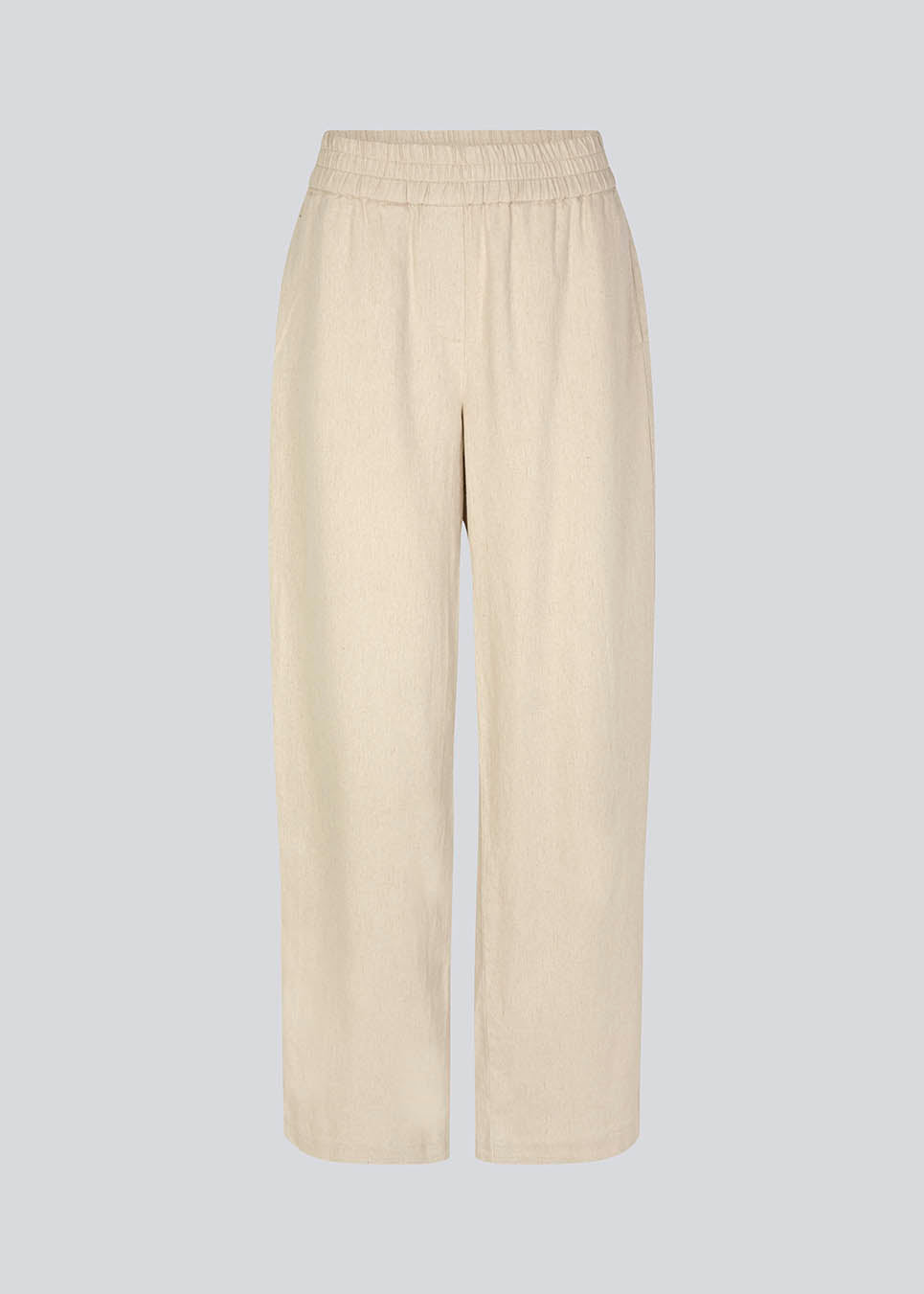 Bukser i beige med afslappet udtryk og pasform i kvalitet af bomuld og hør. HonorMD pants har løse ben og mellemhøj talje med bred elastikkant. Modellen er 175 cm og har en størrelse S/36 på.
