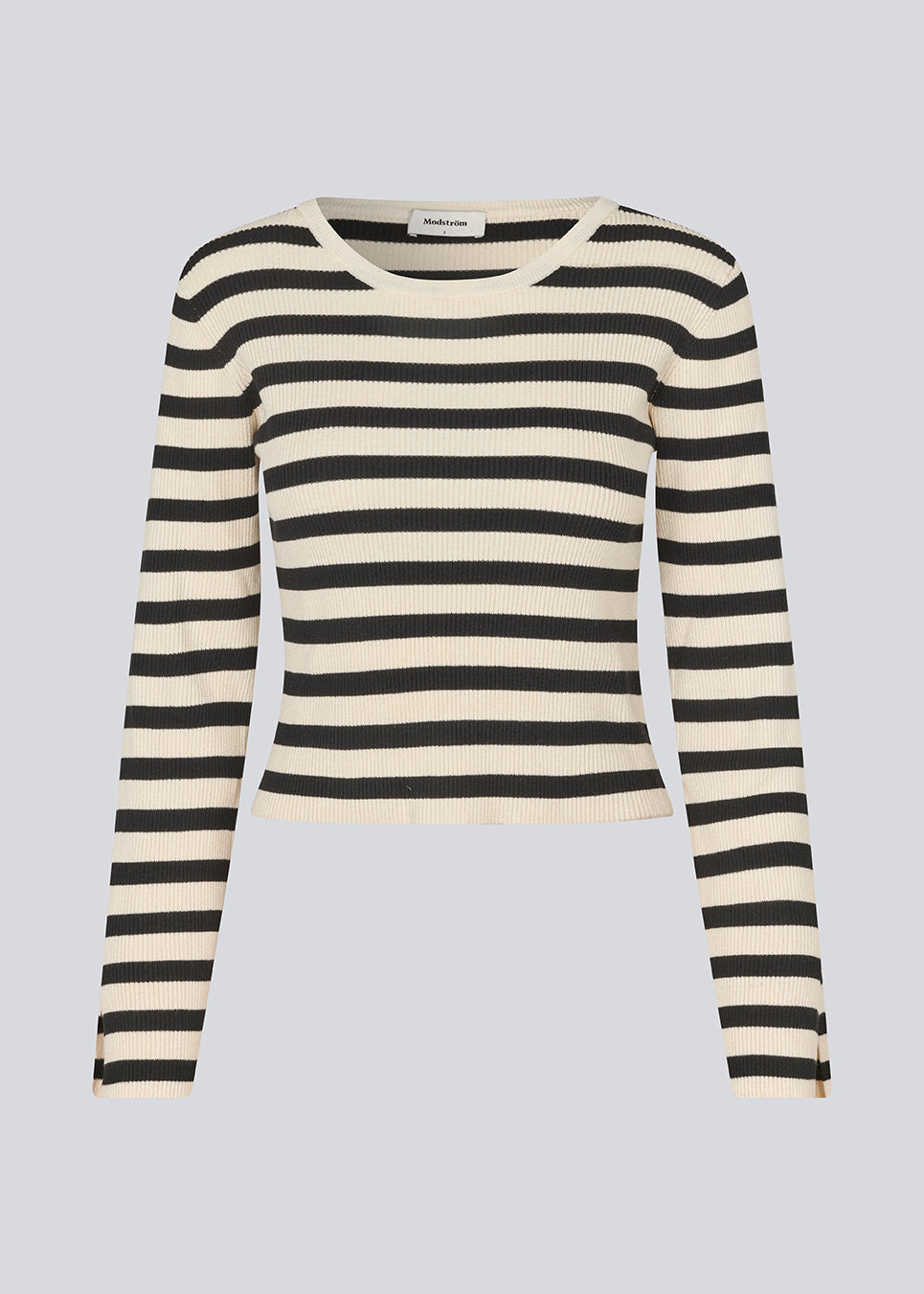 Langærmet trøje i ribstrikket. IbrahimMD o-neck ribkant. Langærmet trøje I ribstrikket. IbrahimMD o-neck er tætsiddende, har en slids i ærmet og ribkant. Trøjen er beige med sorte striber.