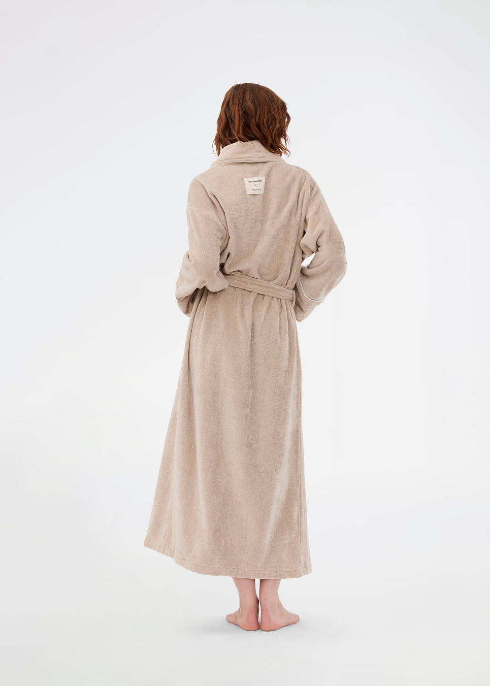 Oversize beige badekåbe i 100% økologisk bomuld. Josefinemd bathrobe har store lommer, bindebånd og kontrastkanter, der giver den et elegant touch. Badekåben har et fint og diskret logo på ryggen. Perfekt til hyggelige morgener. Josefine Vogt (165 cm) og modellen (177 cm) har begge størrelse Small på.
