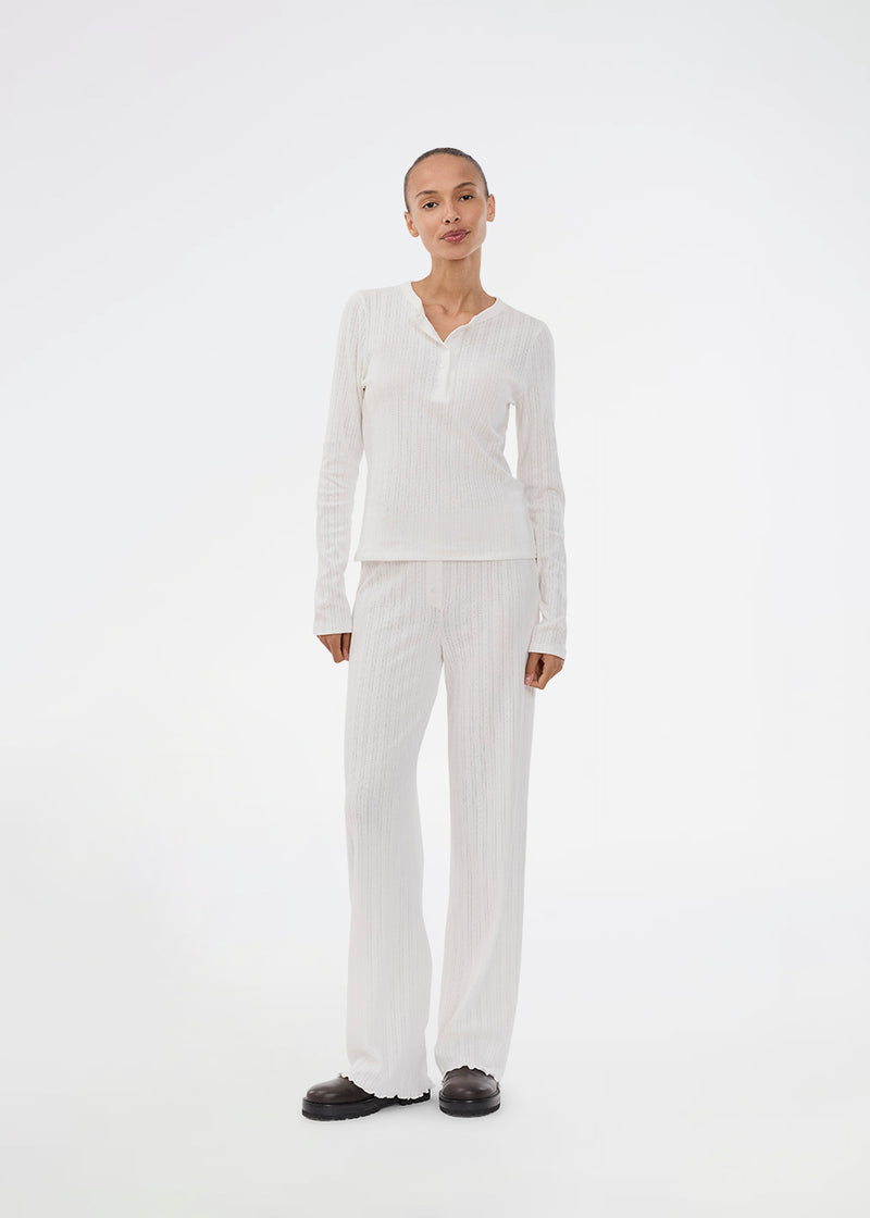 Ponitelle bukser. Josefinemd pants er feminine bukser i pointelle-bomuld med blondekant og diskret hulmønster. Blødt materiale og høj komfort gør dem perfekte til afslapning. Josefine Vogt (165 cm) og modellen (177 cm) har begge størrelse Small på.