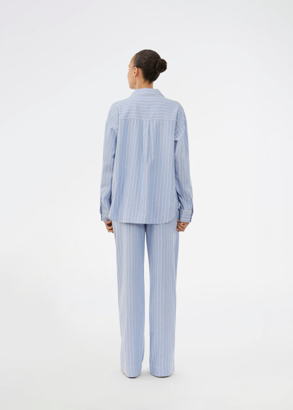 Blåt stribet pyjamas sæt i 100% bomuld. Pyjamas sælges samlet i to dele, skjorte og bukser. Josefinemd pyjamas har et klassisk fit med krave, knaplukning og snørre i bukserne. Sættet har en fin bølgekant og leveres med en matchende pose med logo. Det er ikke muligt at købe forskellige størrelser over- og underdel.&nbsp;