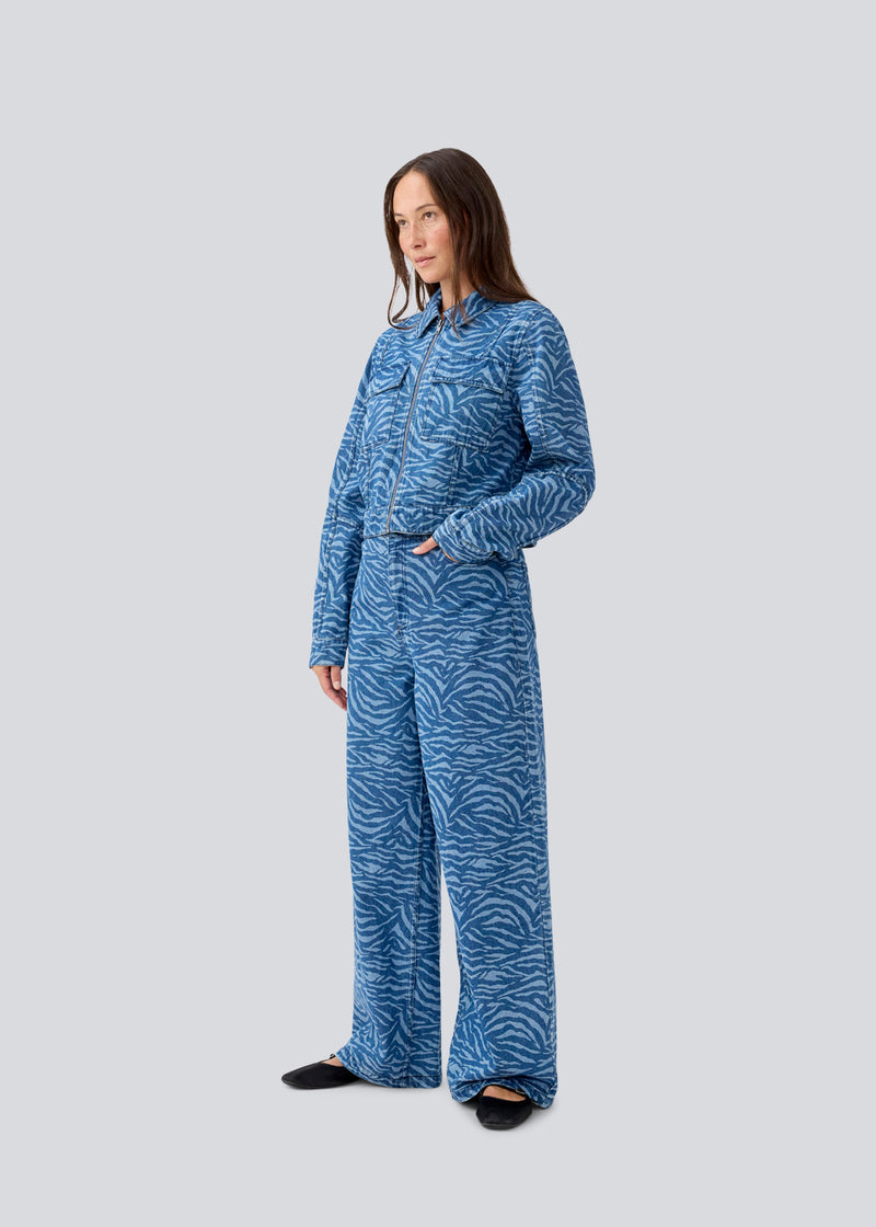 Let cropped jakke i denim. MaseMD print jacket har to brystlommer, skjorte krave og en lynlåslukning fortil. 