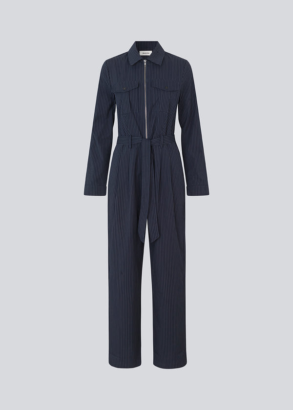 Lang jumpsuit med bælte i taljen og skjortekrave. MathildeMD jumpsuit har lange ærmer, en lynlås lukning fortil og sidelommer.