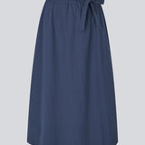 Mellem lang nederdel i 100% økologisk bomuld. MaudeMD skirt har en a form og en elastisk talje med bindebånd. 