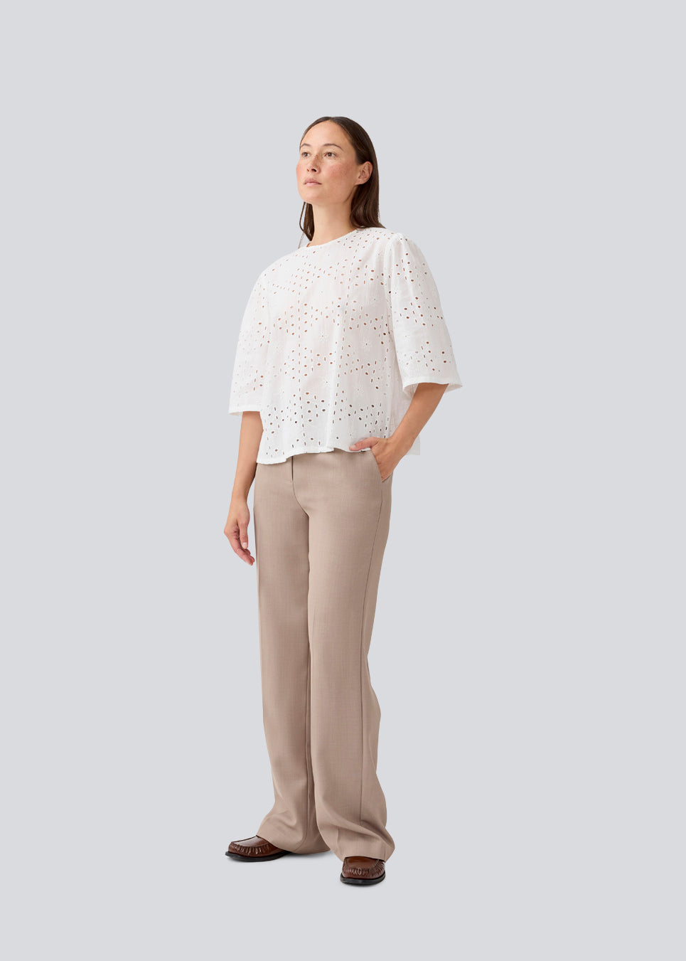 Top med korte ærmer i broderie anglaise. MisoMD top har en løs pasform og en slids med knappelukning i ryggen. 