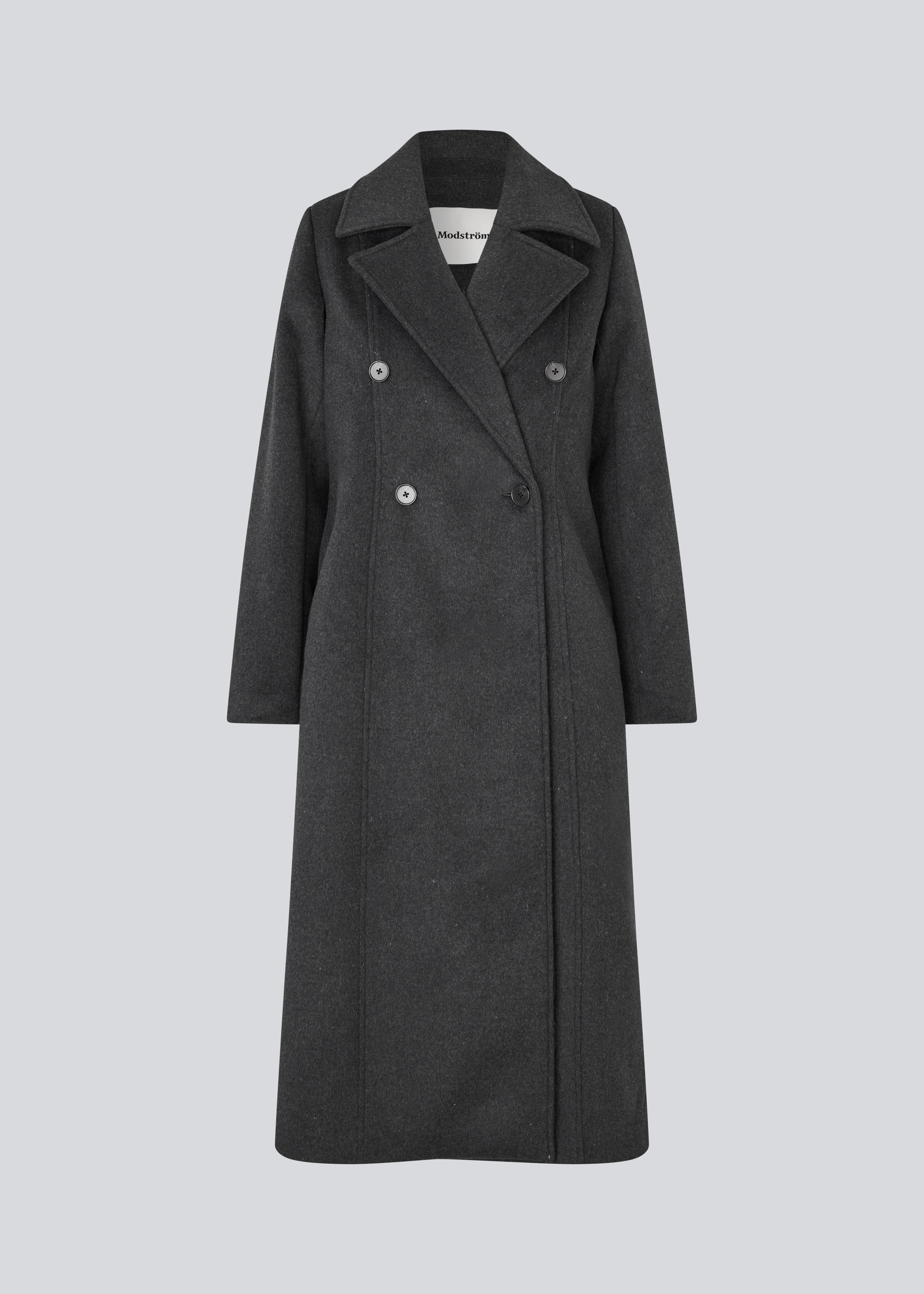 Klassisk, dobbeltradet uldfrakke med krave og revers. Olinamd coat er let figursyet, har foer og en slids bagpå. Modellen er 175 cm og har en str. s/36 på.