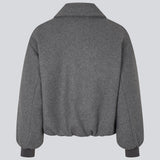 Vatteret bomberjakke i uldblanding. Ommimd jacket brede ærmer med ribkant og en lynlåslukning fortil. Modellen er 175 cm og har en str. s/36 på.