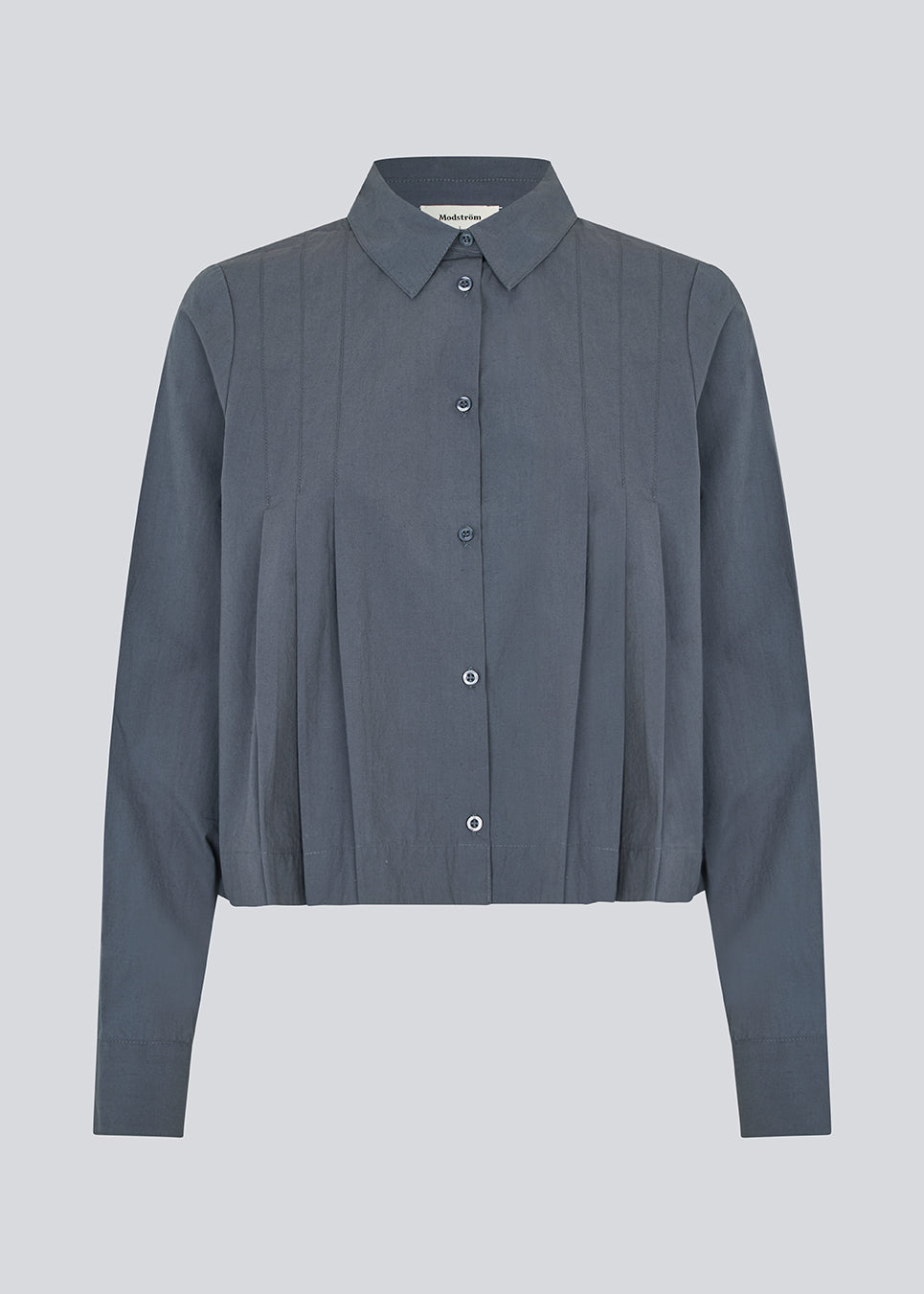 Kort skjorte med læg i 100% økologisk bomuld. Palmermd solid shirt har en skjortekrave og knappelukning fortil.