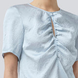 Kortærmet top med rynkedetalje i satin. Parkermd &nbsp;top has en åbning fortil og en usynlig lynlås &nbsp;i ryggen. Modellen er 175 cm og har en str S/36 &nbsp;på.