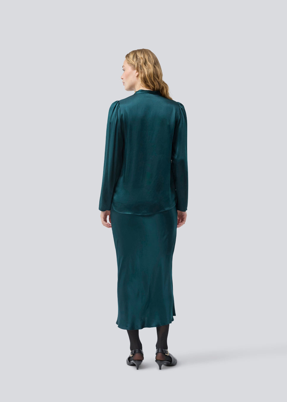 Grøn lang nederdel med vidde i satin. Parveenmd skirt har en elastik i taljen. Modellen er 175 cm og har en str. s/36 på.