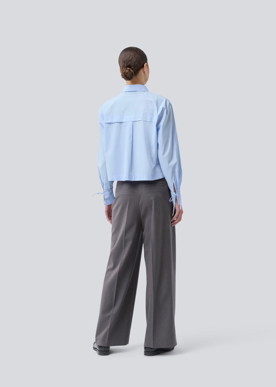Grå lange habitbukser med brede ben. Primrosemd pants har pressefolder og sidelommer. Modellen er 175 cm og har en str. s/36 på.