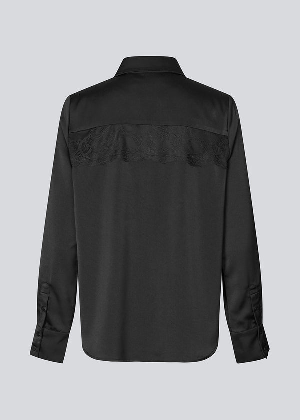 Løs skjorte i satin med blondedetalje på brystet. Prudencemd shirt har en skjortekrave og lange brede ærmer