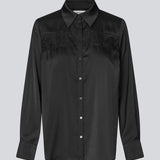 Løs skjorte i satin med blondedetalje på brystet. Prudencemd shirt har en skjortekrave og lange brede ærmer