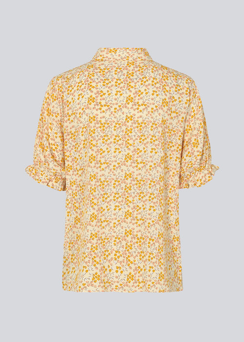 Blomstret skjorte i farven Bobble Bloom Peach med korte, puffede ærmer med elastik. RavenMD print shirt har normal krave og knapper foran. Pasformen er afslappet. Modellen er 173 cm og har en størrelse S/36 på