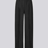 Sorte bukser med brede ben og pressefold. Ridermd pants har sidelommer og elastisk talje – stilrene og komfortable på én gang.